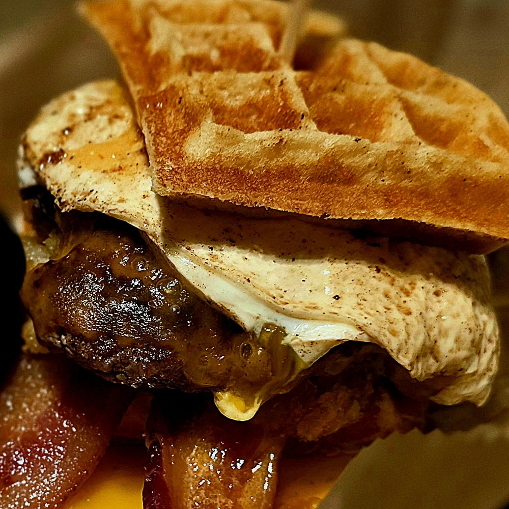 Burger with egg and bacon on a waffle bun